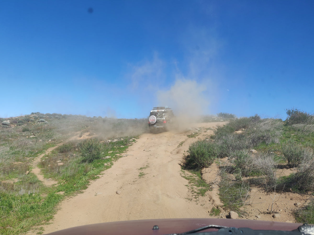 Honda Element kicking up dust on off-road trail – Aerogenics adventure parts